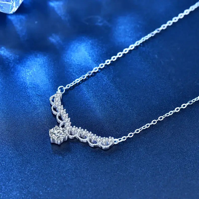 Delicate silver necklace featuring a curved 0.5 Carat Moissanite Pendant by Telles Jewelry