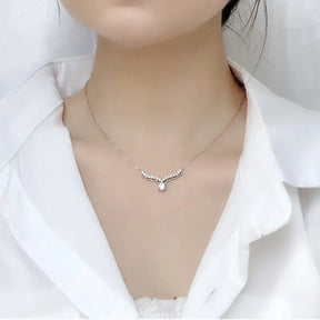 Delicate silver necklace with a 0.5 Carat Moissanite Pendant featuring a central pearl