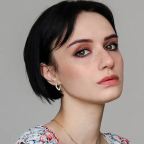 Young woman with green eyes showcasing Sterling Silver Teardrop Hoop Earrings with lab grown diamonds