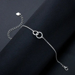 Delicate silver Elegant Infinity Bracelet featuring interlocking circles and lab grown diamond charm