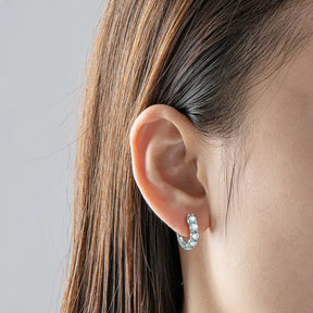 Silver hoop earrings adorned with small gemstones, featuring Luxury Lab Grown Diamond design