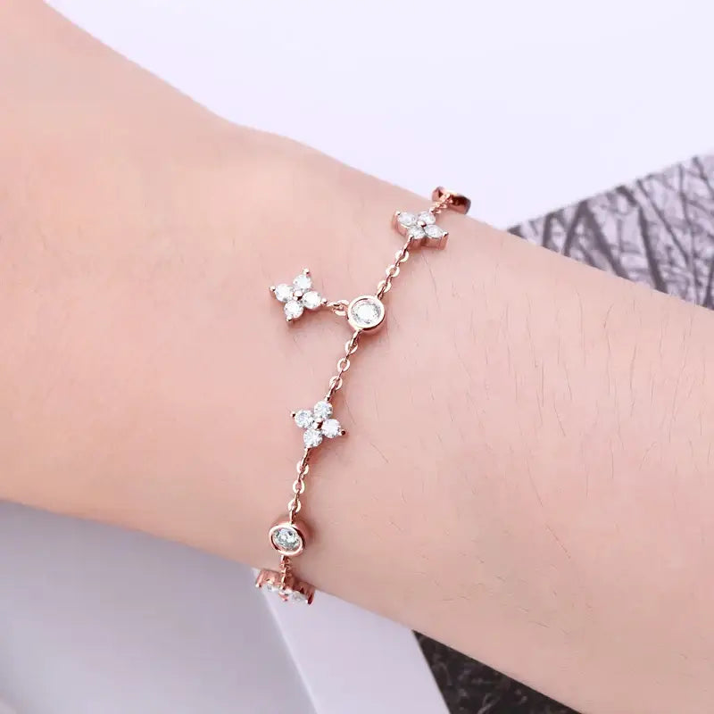 Delicate silver four-leaf clover bracelet with lab grown diamonds and butterfly charms