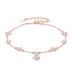 Delicate rose gold anklet adorned with crystal flowers, complementing the Four-Leaf Clover Bracelet