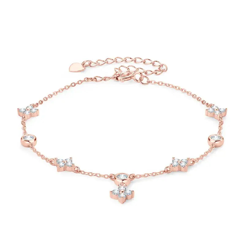 Delicate rose gold anklet adorned with crystal flowers, complementing the Four-Leaf Clover Bracelet