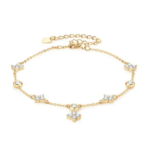 Delicate gold anklet adorned with crystal charms enhancing the Four-Leaf Clover Bracelet