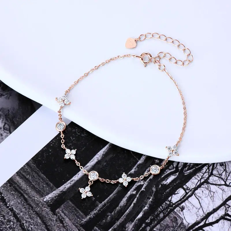 Delicate rose gold Four-Leaf Clover Bracelet with Lab Grown Diamonds and floral charms