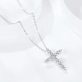 Silver necklace featuring a moissanite cross pendant with gemstones and a sterling silver chain