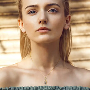 Young woman in teal off-shoulder top showcasing a genuine lab grown diamond necklace