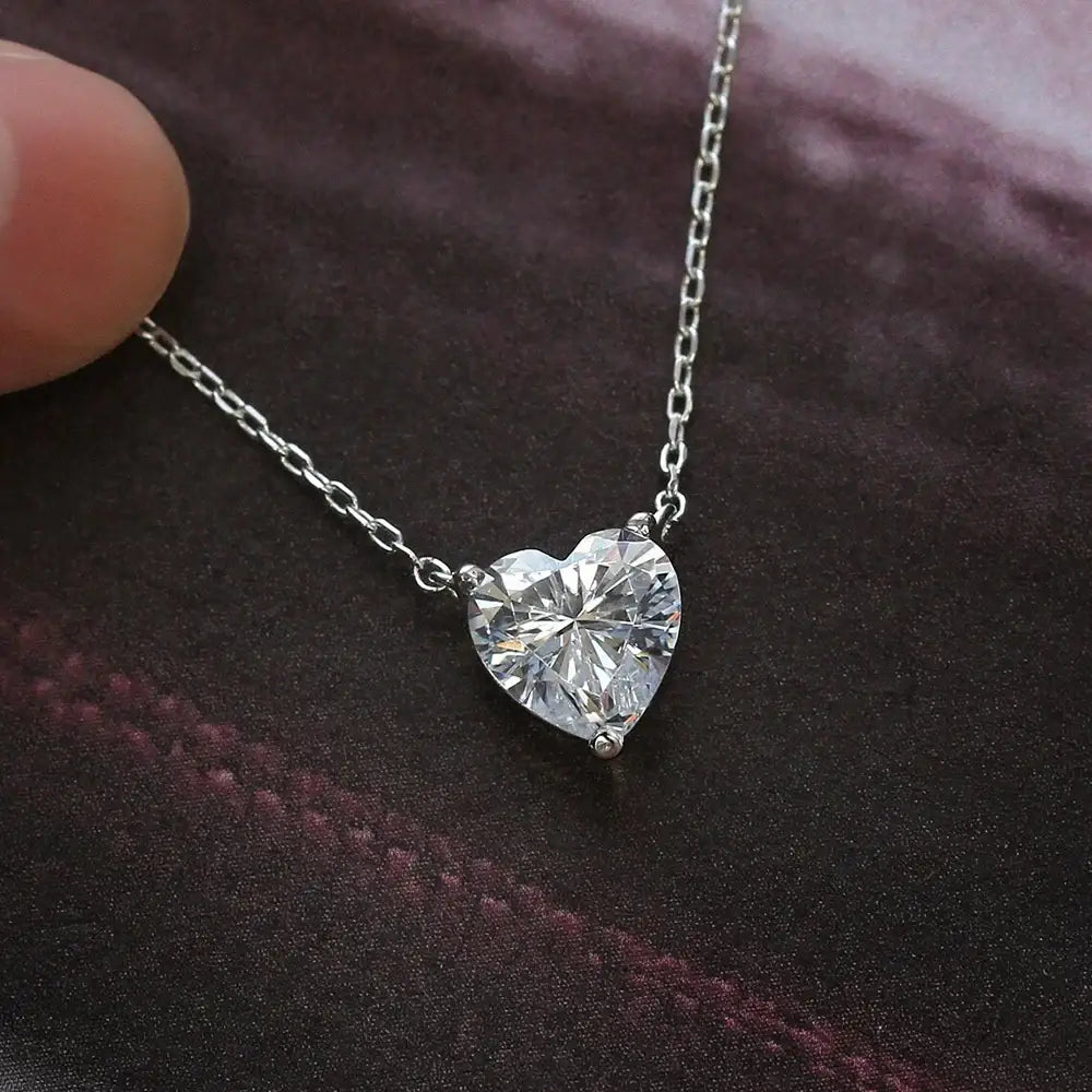 Heart-shaped diamond pendant hangs on a delicate sterling silver chain in Moissanite jewelry