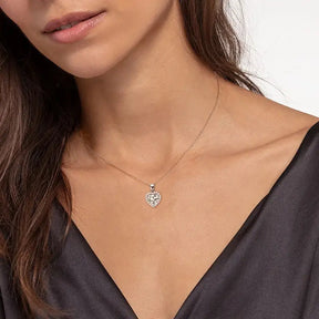 Delicate silver necklace showcasing a floral pendant with a heart shaped lab grown diamond