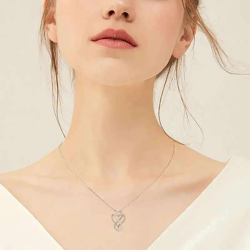 Delicate silver necklace featuring a Lab Grown Diamond Heart Infinity Pendant