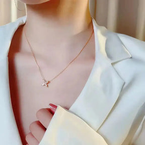 Delicate gold necklace with small cross pendant and lab grown diamond accents