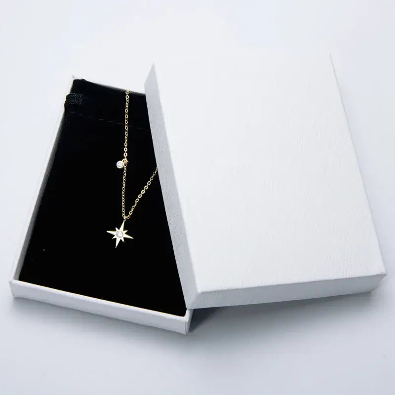 Delicate gold necklace with diamond star pendant in white jewelry box, lab grown diamond