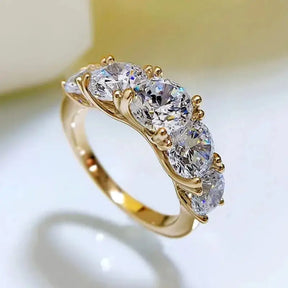 Gold ring with five round brilliant-cut diamonds, ideal for a Moissanite wedding ring