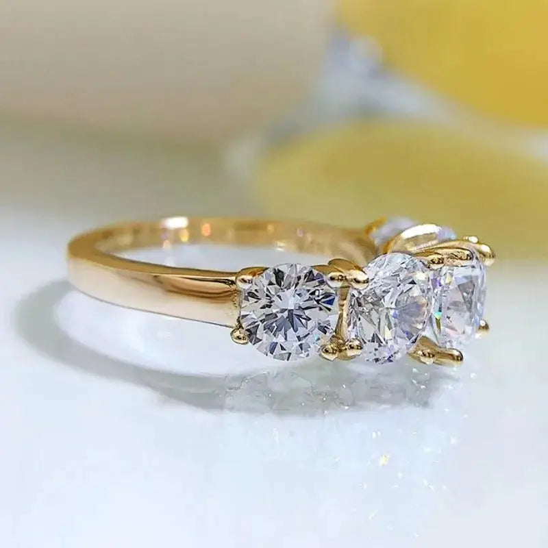 Gold ring with three round diamonds, a stunning Moissanite wedding band