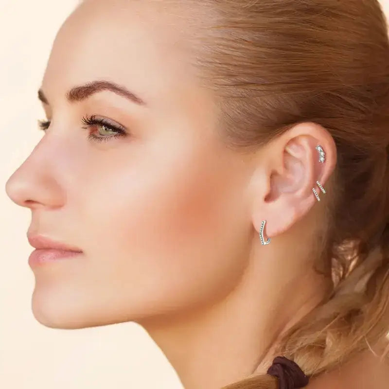 Profile view of a woman showcasing Moissanite Diamond Hexagonal Huggie Earrings