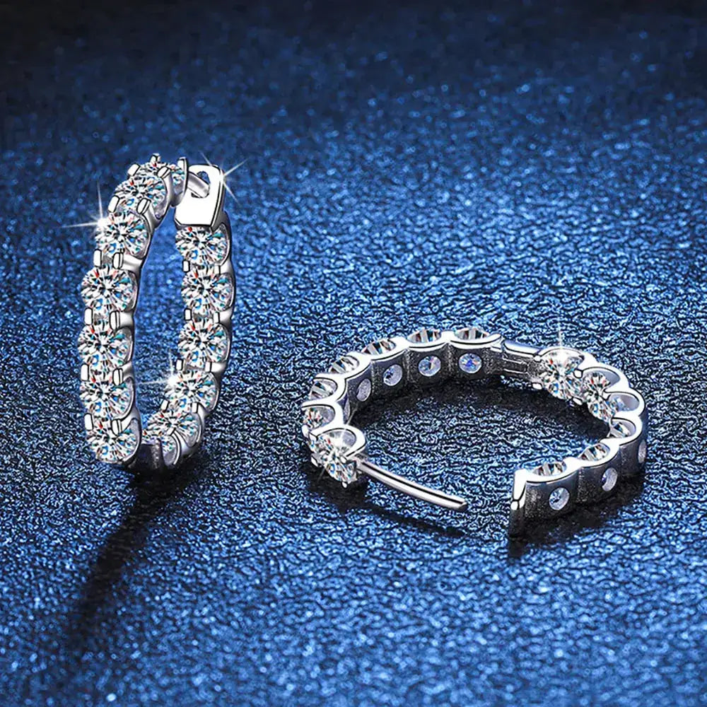 Pair of Moissanite hoop earrings on a blue surface showcasing elegant S925 Silver design