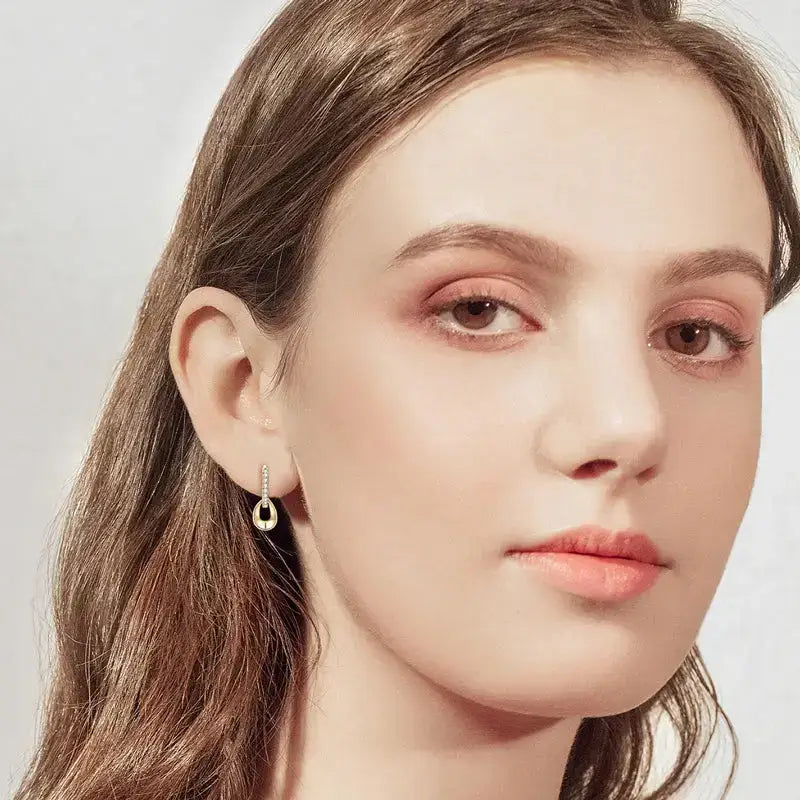 Young woman with brown hair showcasing Moissanite Hoops Earrings with detachable dangle