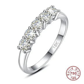 Diamond-studded moissanite ring in solid 18K gold with five stones in a row