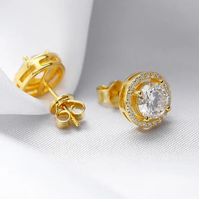 Gold stud earrings with round diamonds in halo setting, embodying Radiant Elegance