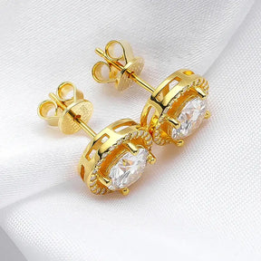 Gold stud earrings with clear gemstones in ornate settings embody Radiant Elegance and luxury