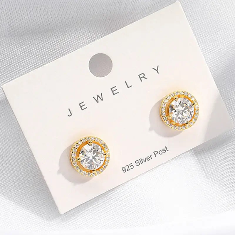 Pair of gold-toned Moissanite stud earrings showcasing radiant elegance with clear gemstones