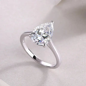 Pear cut moissanite diamond ring with silver band, elegant and timeless design