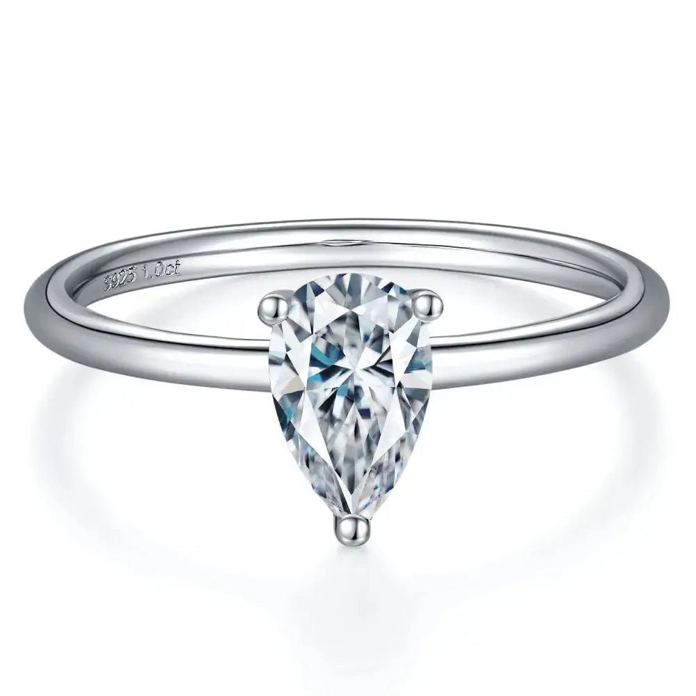 Pear cut moissanite diamond ring features an elegant silver band, timeless engagement jewelry