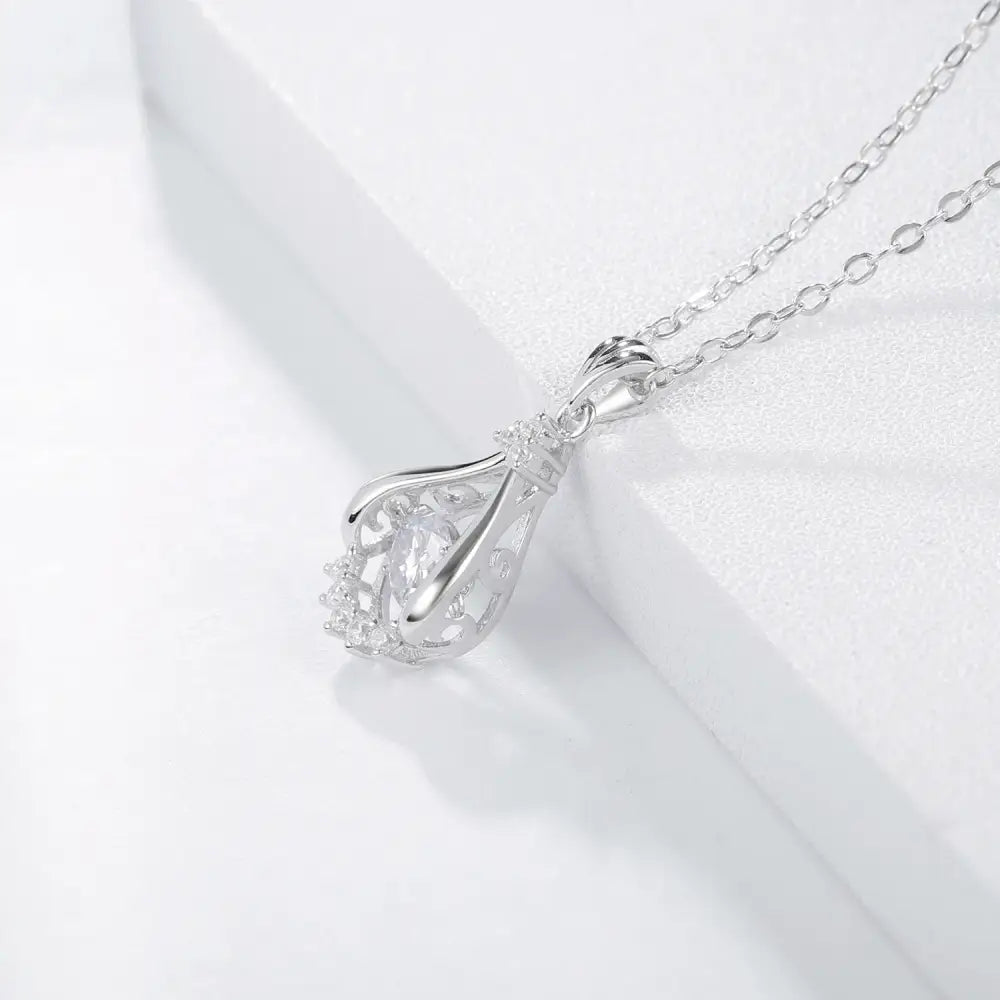 Silver pendant necklace with teardrop charm featuring lab grown diamond in sunflower design