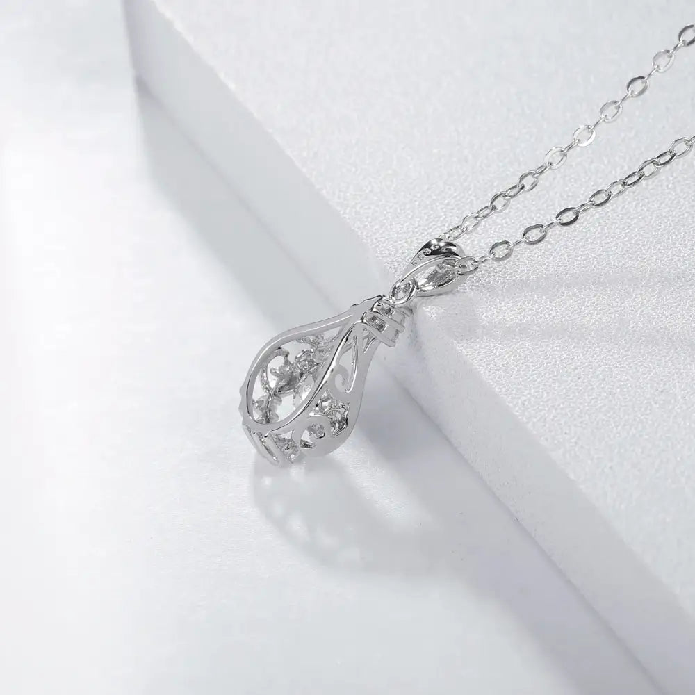 Delicate silver grown diamond pendant featuring teardrop-shaped crystal in sunflower design