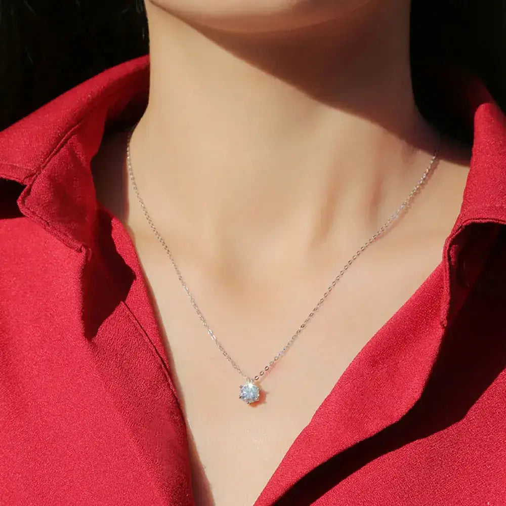 Delicate silver pendant necklace featuring a small blue real Moissanite pendant