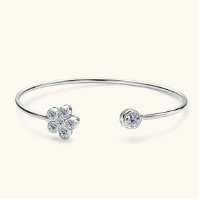 Silver bracelet featuring a flower-shaped cluster of lab grown diamonds and a solo gemstone