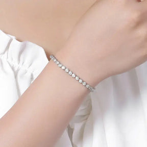 Delicate Round Moissanite Diamond Tennis Bracelet in 925 Sterling Silver on a wrist