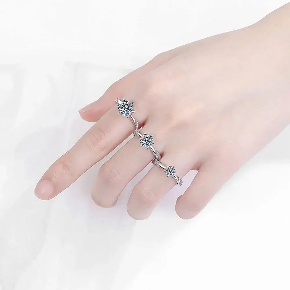 Three s925 sterling silver rings with star-shaped gemstone settings on a hand