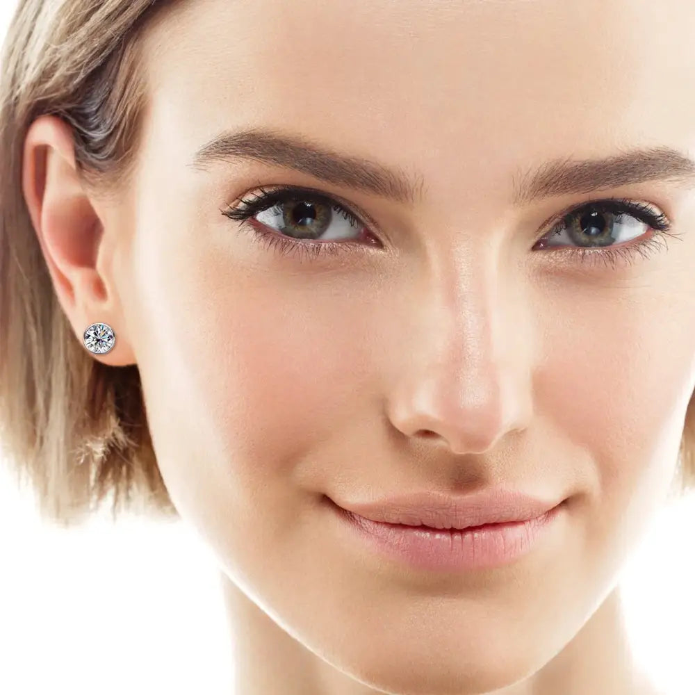 Close-up portrait of a smiling woman wearing Silver 925 Round Diamond Bezel Earrings