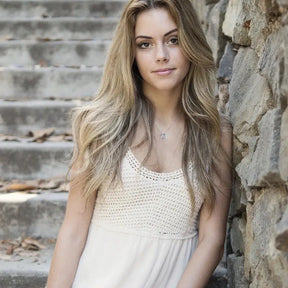 Young woman in a white top showcasing the Six-Manifold Star Dancing Pendant Necklace with lab grown diamond