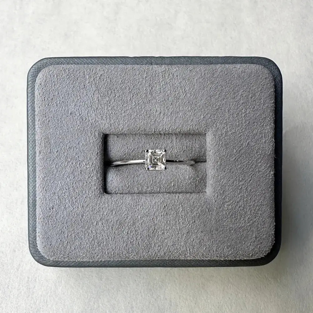 Diamond engagement ring in gray velvet box featuring Asscher cut Moissanite diamond