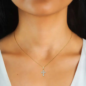 Gold necklace featuring a cross pendant with gemstones, perfect sterling silver piece