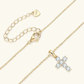 Gold necklace featuring a diamond-studded cross pendant on sterling silver chain