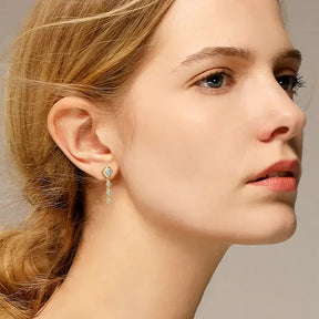 Profile view of a person wearing Square Moissanite Drop Earrings in hypoallergenic design