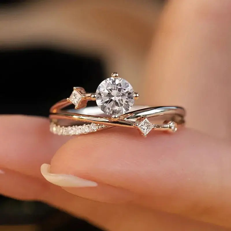 Diamond engagement ring featuring a delicate crossover band design in Star Trail Moissanite