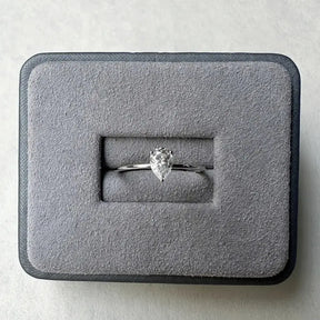 Pear-shaped moissanite diamond ring in gray velvet box, a sterling silver pear anniversary gift