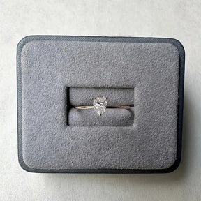 Diamond engagement ring in gray velvet box, showcasing Sterling Silver Pear Moissanite Diamond