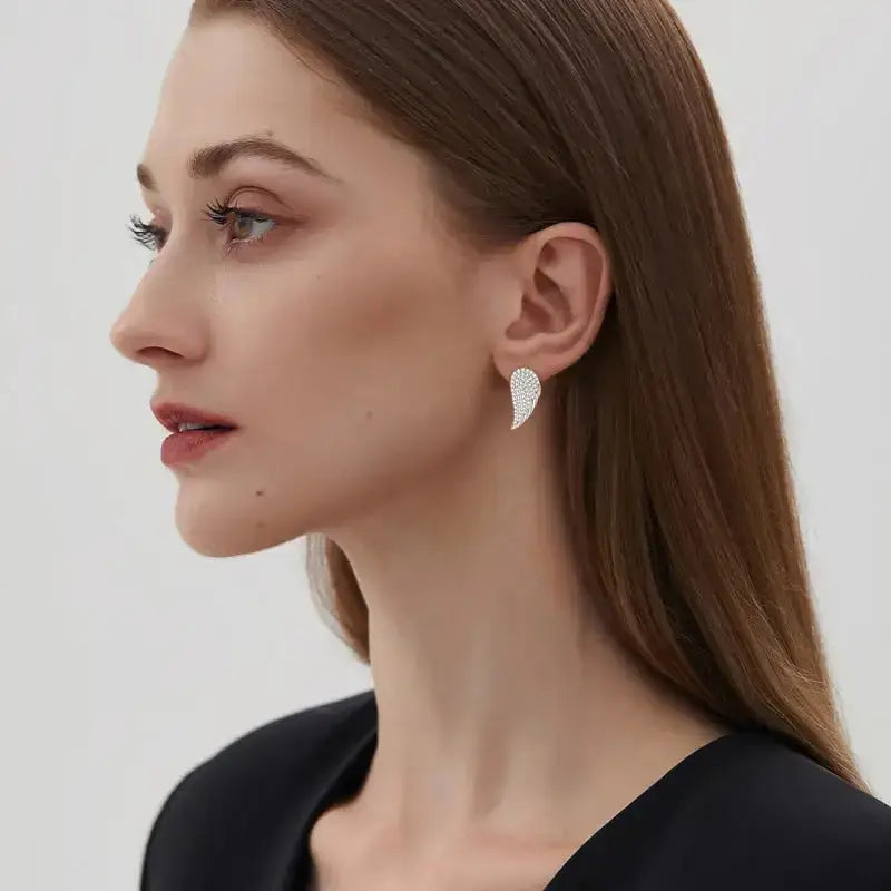 Woman with brown hair wearing Wing of Angel Stud Earrings with Moissanite Diamonds